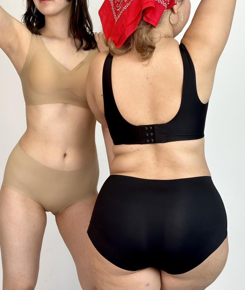 Two women pose in underwear: one in a nude bra and briefs, the other in a black bra and briefs with a red bandana.
