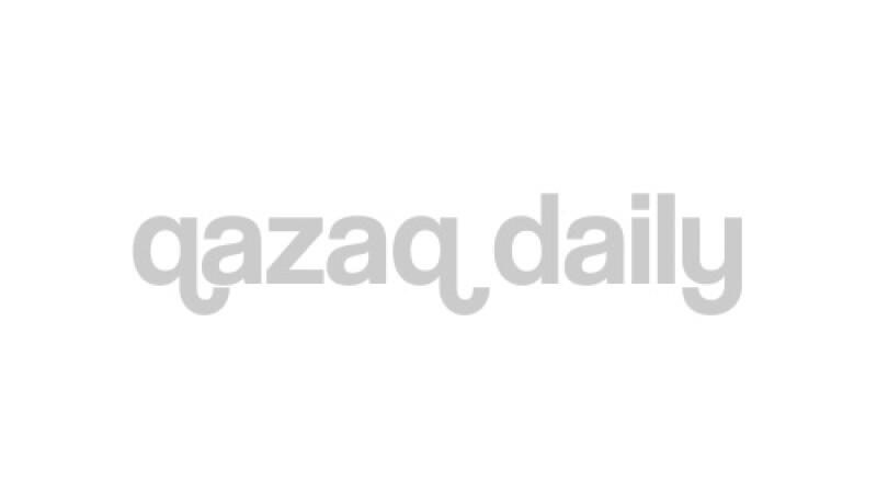 The image shows the text "qazaq daily" in light gray against a white background.