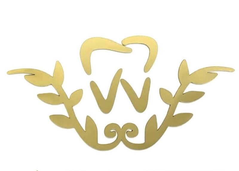 The image features a golden dental logo with a tooth shape at the top, two 'V' shapes below, and stylized leaves on either side.