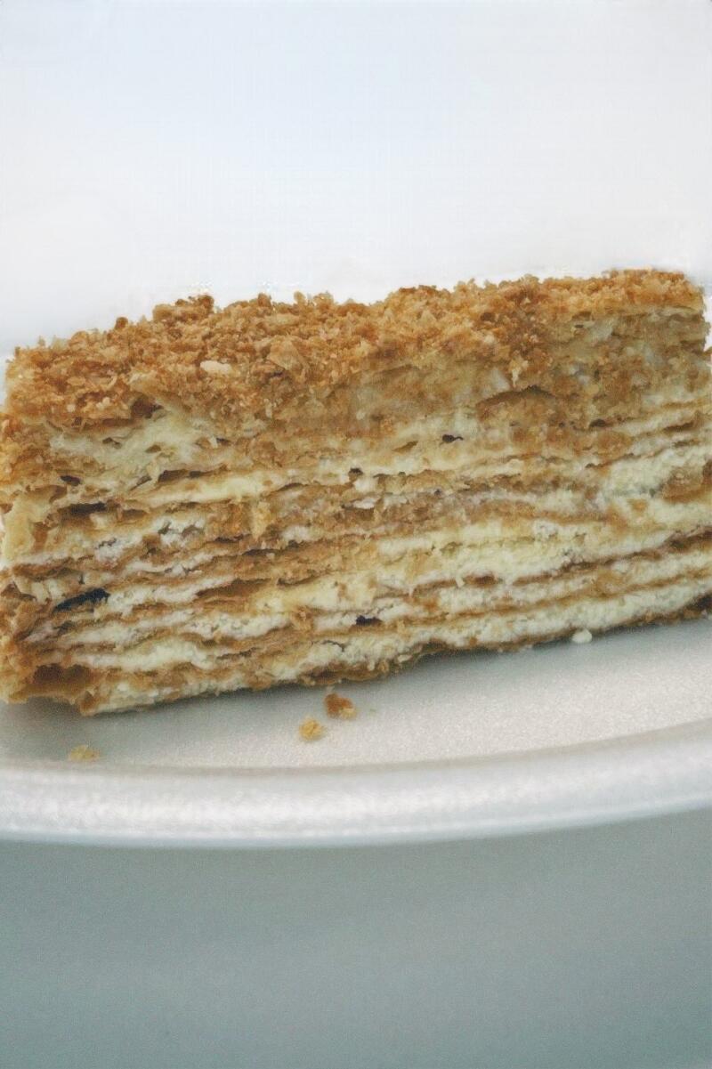 A layered Napoleon cake with a crumbly topping.