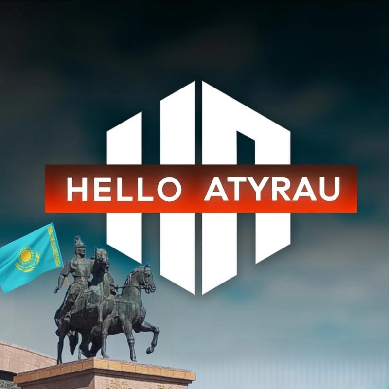 The image features a statue of two warriors on horseback, a waving Kazakhstan flag, and the text "HELLO ATYRAU" in a red banner, set against a blurred gray sky and a stylized white geometric shape.