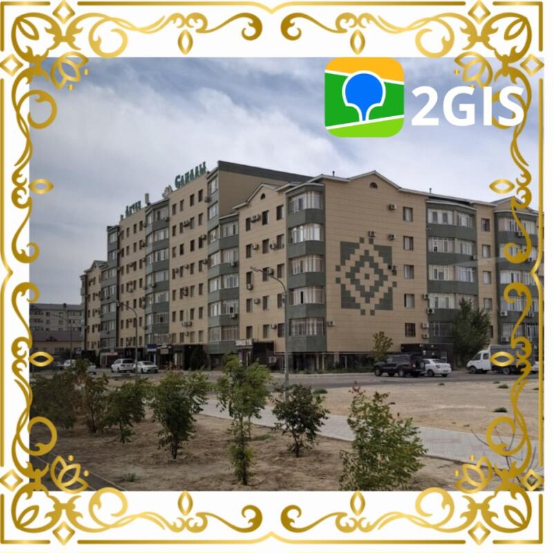 The image shows an urban landscape with a multi-story building, possibly an apartment complex or hotel, under a cloudy sky, featuring the 2GIS logo, with the text 'HOTEL SAKAAH' visible atop the building.