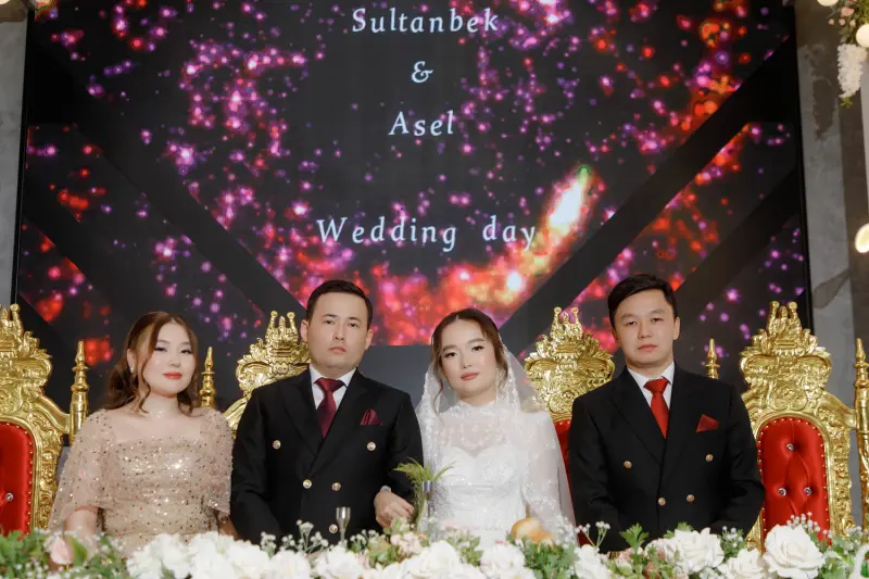 A wedding photo shows two couples sitting at a table with a floral arrangement, with "Sultanbek & Asel Wedding day" displayed in the background.