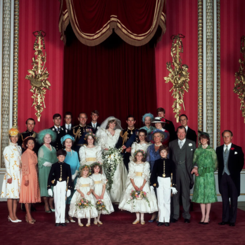 A group portrait shows Princess Diana and Prince Charles' wedding party standing in front of a red curtain backdrop.