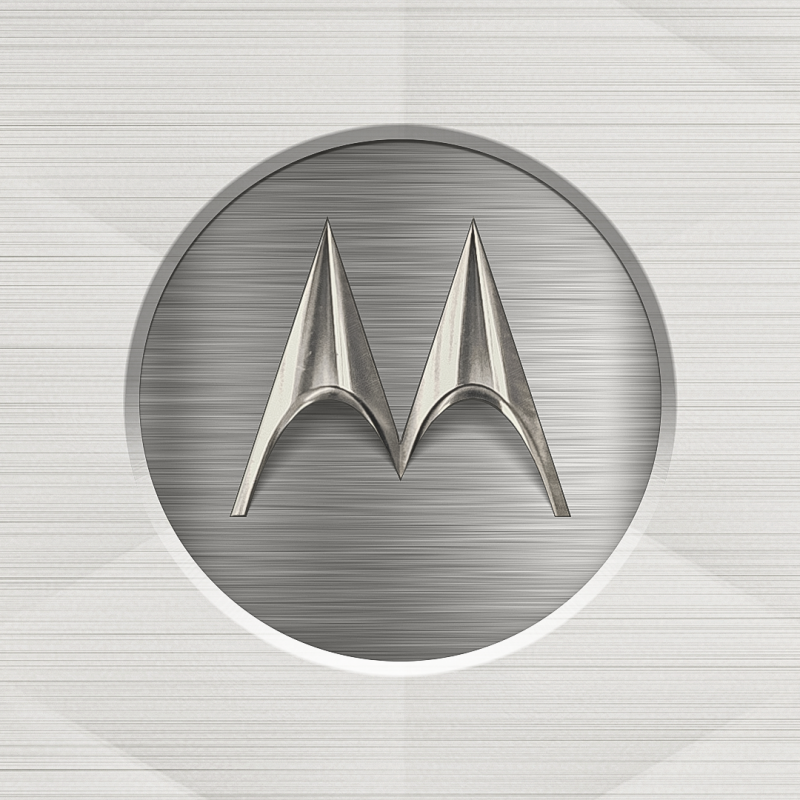 The image features a metallic Motorola logo within a recessed circular frame on a horizontally brushed metal background.