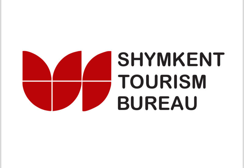 The image shows the logo for the Shymkent Tourism Bureau, featuring a stylized red tulip-like design to the left of the text "SHYMKENT TOURISM BUREAU" in black.