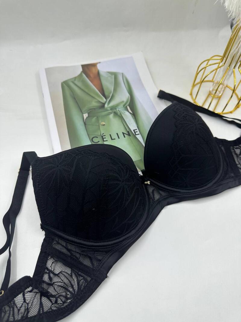 A black lace bra is displayed in front of a fashion magazine with the text 'CÉLINE' visible on the cover.