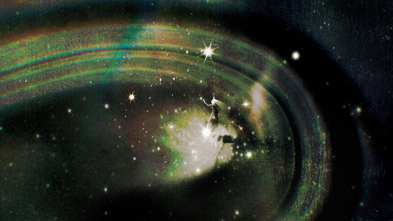 The image shows a spiral galaxy with bright stars and nebulous regions, surrounded by a faint, colorful ring.