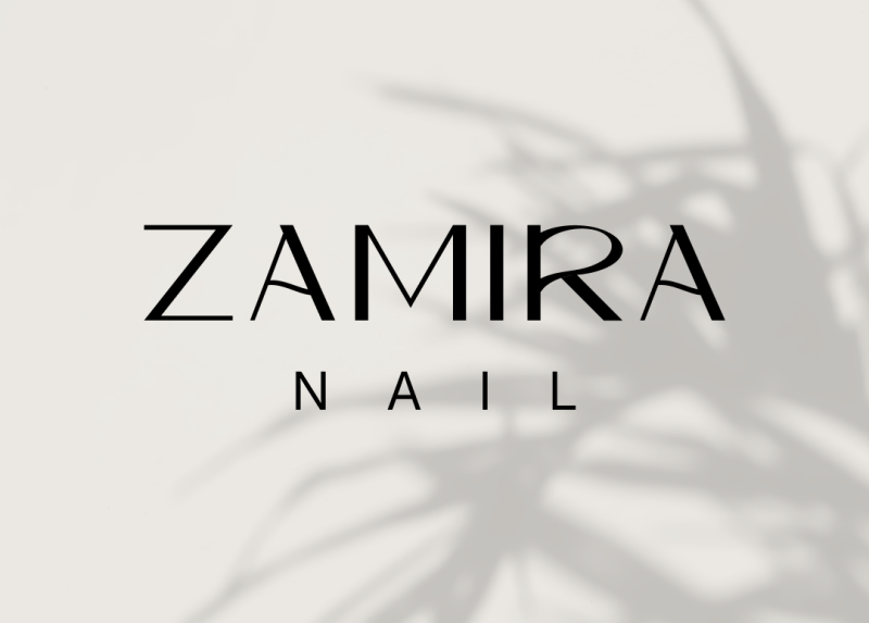 The image features the text "ZAMIRA NAIL" in a stylized, sans-serif font, with a shadow of a plant in the background.