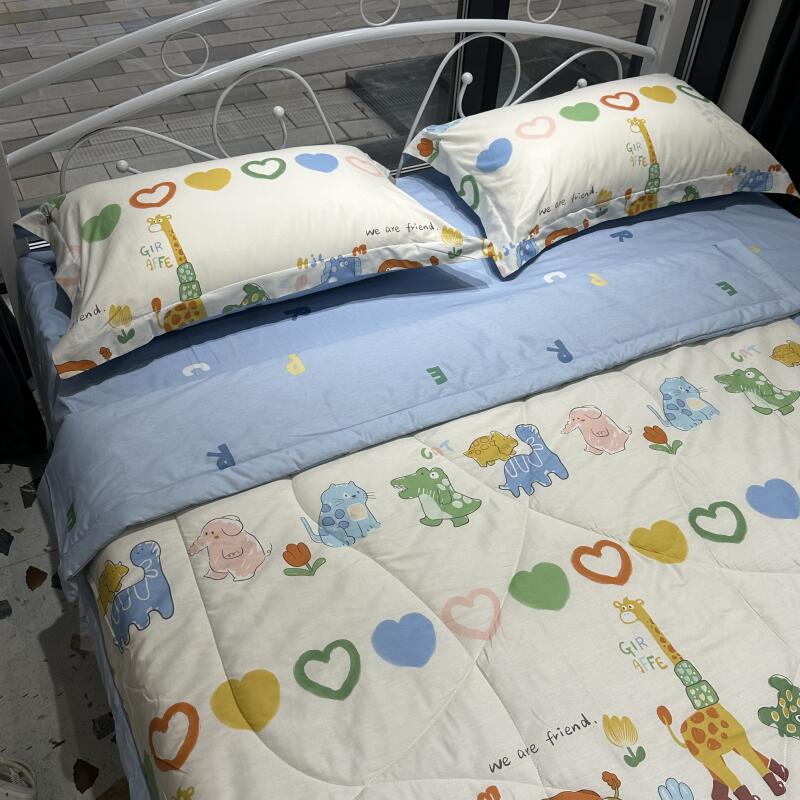 A bed with a white metal frame is covered in bedding featuring cartoon animals and hearts, with the text 'GIR AFFE' and 'we are friend' printed on the pillows and comforter.