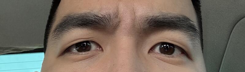 A close-up shot of a person's face shows brown eyes and eyebrows.
