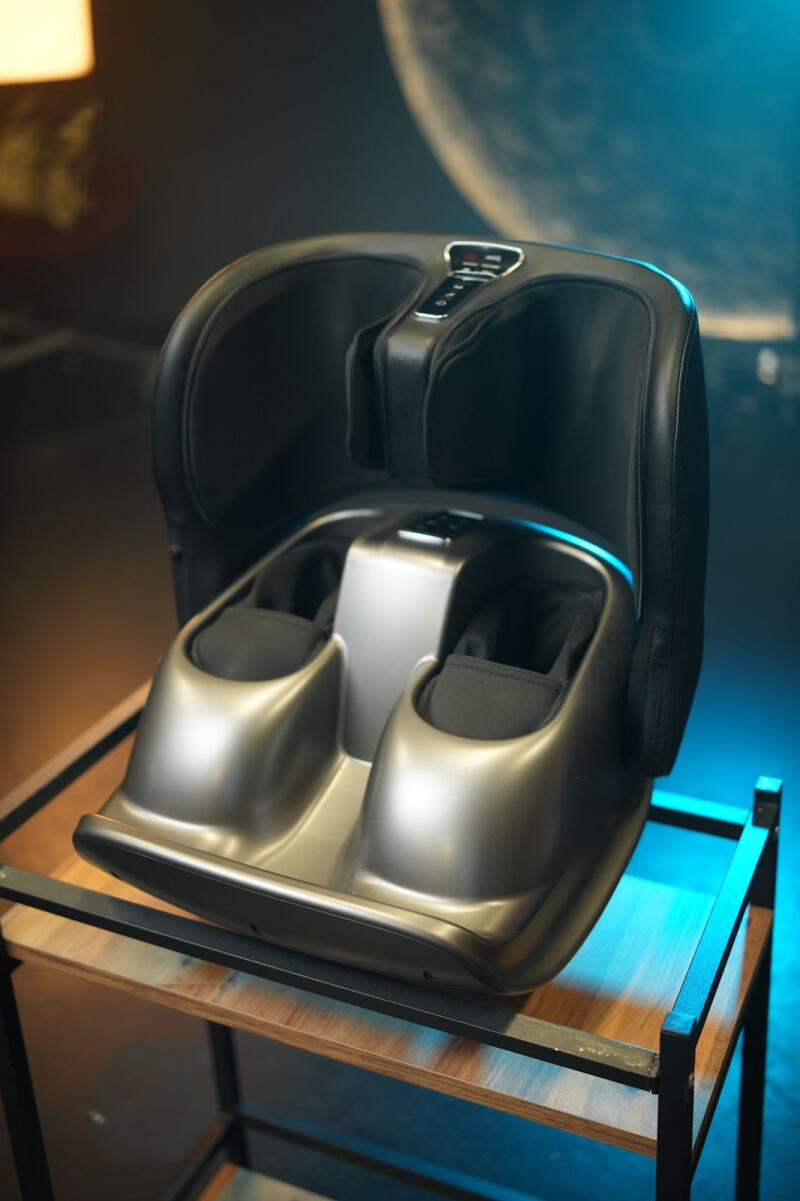 A foot massager is placed on a small wooden shelf.