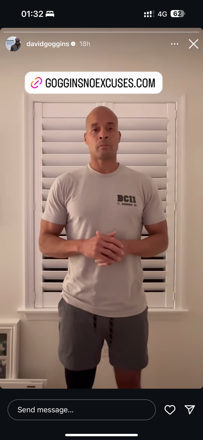 David Goggins is standing in front of a window wearing a grey t-shirt and shorts, with a link to GOGGINSNOEXCUSES.COM.