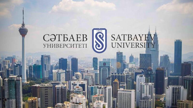 The photo shows the skyline of a city with tall buildings and towers, with the logo and name of "Satbayev University" superimposed on the image.