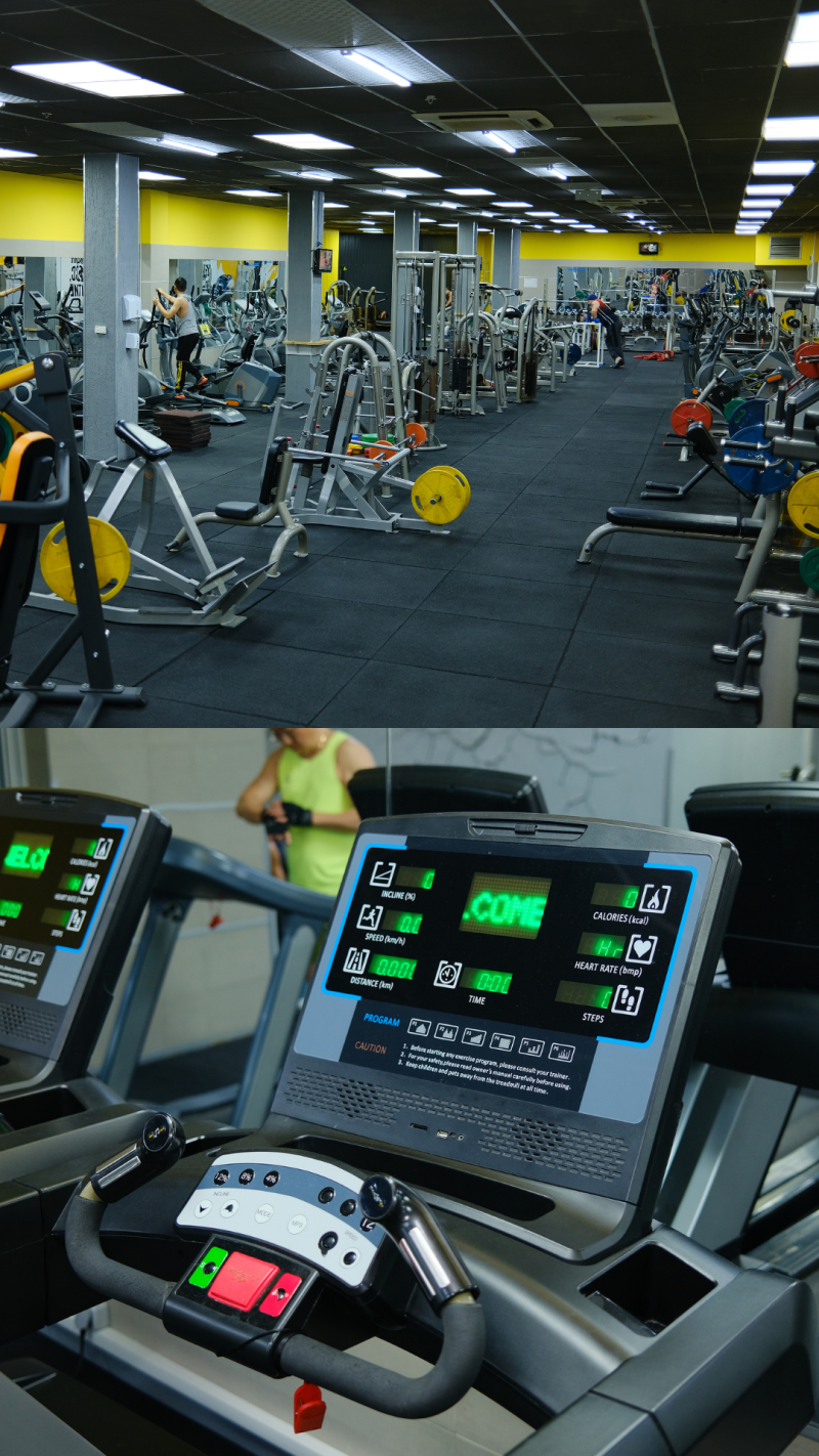 The image shows the interior of a gym with various exercise machines and equipment; in the foreground, there's a close-up of a treadmill console displaying digital information such as incline, speed, distance, time, calories, heart rate, and steps, along with a welcome message.