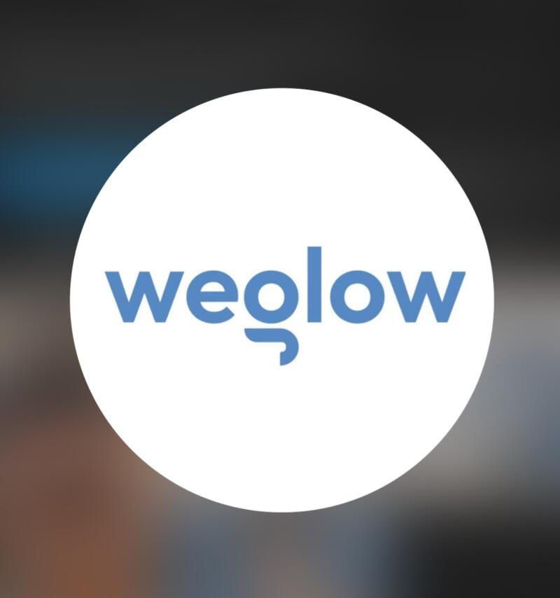 The image features the word "weglow" in blue letters, set against a white circle. The background is blurred.