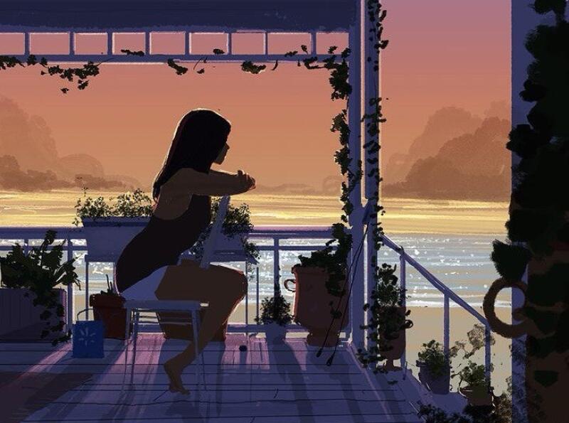 A woman sits on a chair on a porch overlooking the sea at sunset, with plants and foliage decorating the scene.