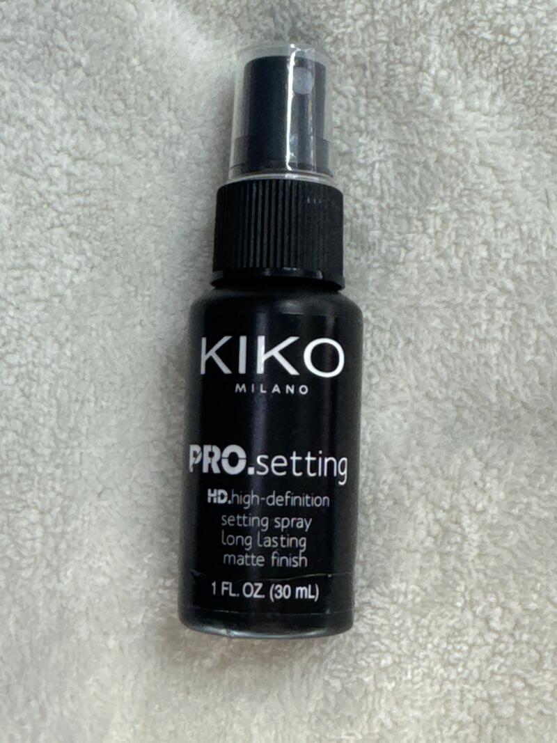 A black spray bottle of KIKO Milano PRO.setting HD high-definition setting spray long lasting matte finish is on a white surface.