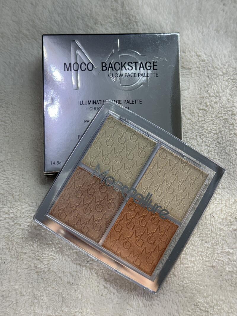 A MOCO BACKSTAGE glow face palette is displayed with its packaging, featuring four different shades of highlighter.