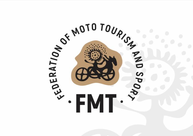 The logo features the words "FEDERATION OF MOTO TOURISM AND SPORT" in a circular pattern surrounding a graphic of a person with a sun-like head riding a bicycle with a horse head. Below the graphic is the abbreviation "FMT".