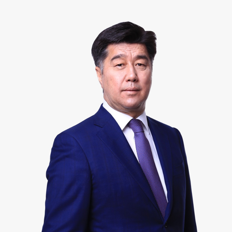 A portrait of a middle-aged Asian man in a blue suit and patterned tie.
