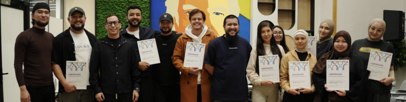 A group of diverse people are standing in a row, holding certificates with a colorful logo of interconnected figures.
