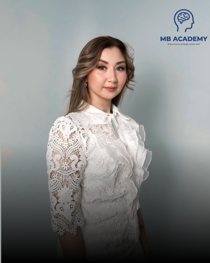 A woman is posing in a white lace shirt with the MB Academy logo in the upper right corner.