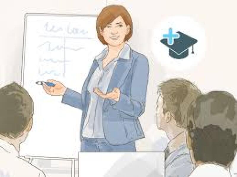 A woman is presenting in front of a whiteboard with writing and a group of people, with a graduation cap icon nearby.