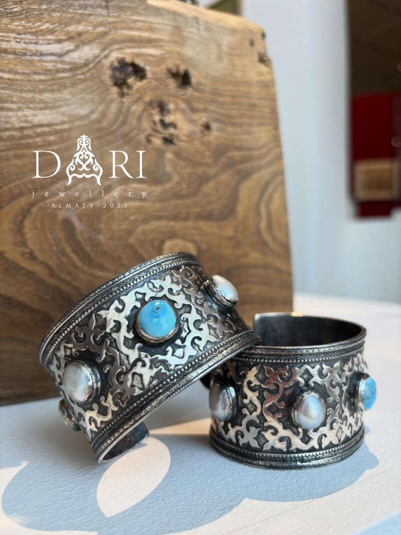 The image features two silver bracelets with turquoise and pearl stones on a white surface, with the text "DARI jewellery ALMATY 2025" in the background.