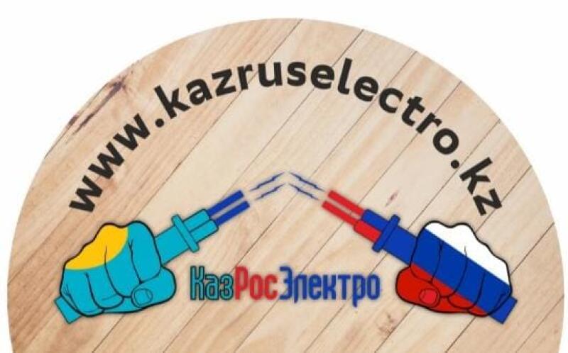 The image shows a wooden circle with the text "www.kazruselectro.kz" in black around the top edge. Two hands colored with the flags of Kazakhstan and Russia are holding wires that appear to be sparking. Below the wires, the text "КазРосЭлектро" is written in blue and red.
