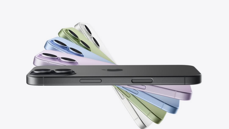 Several iPhones in different colors are arranged in a fan-like pattern against a white background, with the black iPhone positioned horizontally at the front.