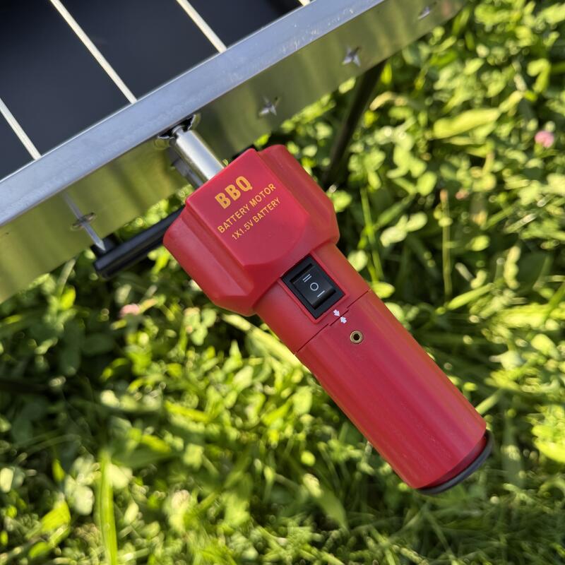 A red BBQ battery motor, labeled "BBQ Battery Motor 1x1.5V Battery," is attached to a grill or cooking apparatus, and it features a switch and a power port.