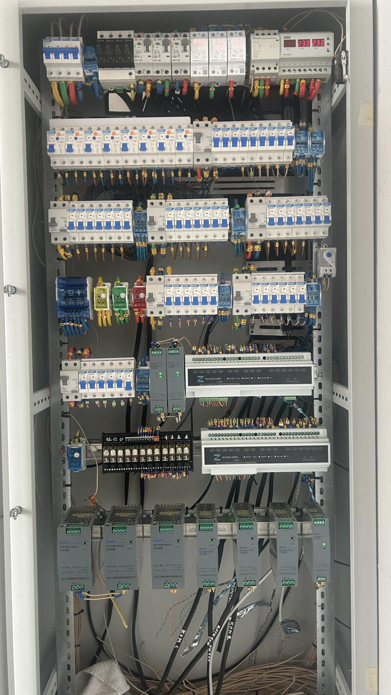 The photo shows an open electrical panel filled with circuit breakers, wiring, and other electrical components.