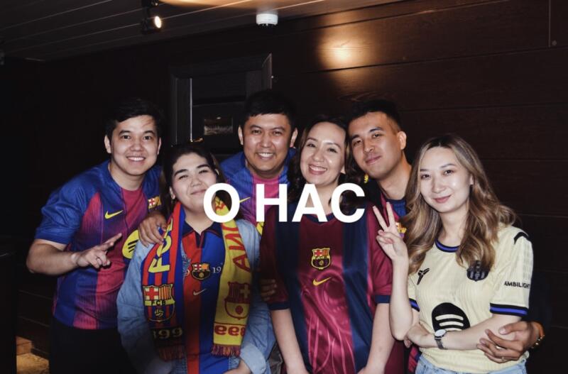 A group of six people is posing, some wearing FC Barcelona jerseys, and one is wearing a scarf with the FC Barcelona logo.