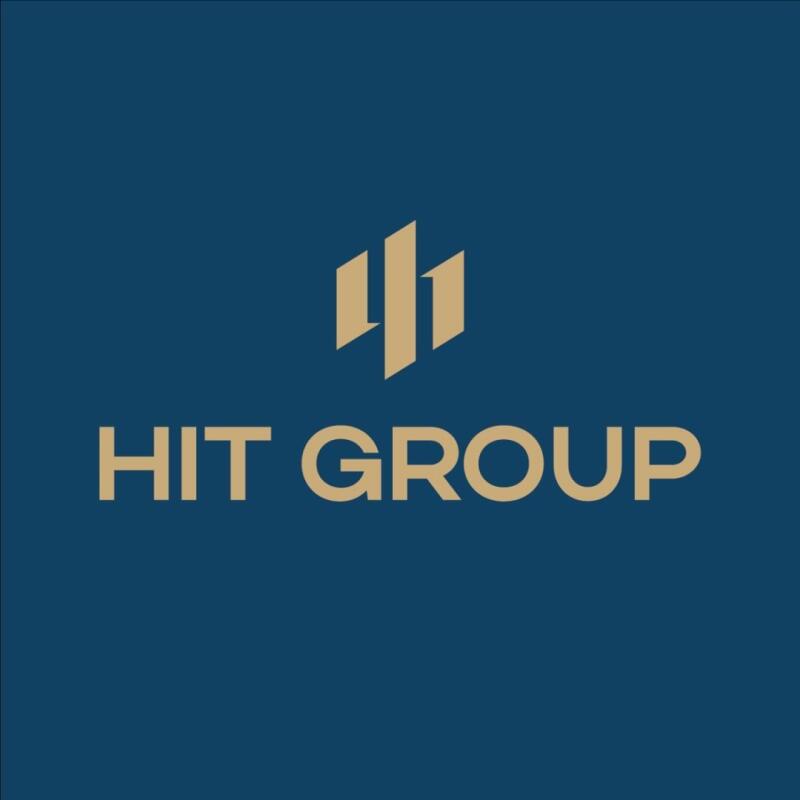 The image displays the "HIT GROUP" logo in gold color on a dark blue background, with a symbol consisting of three vertical lines of varying lengths above the text.