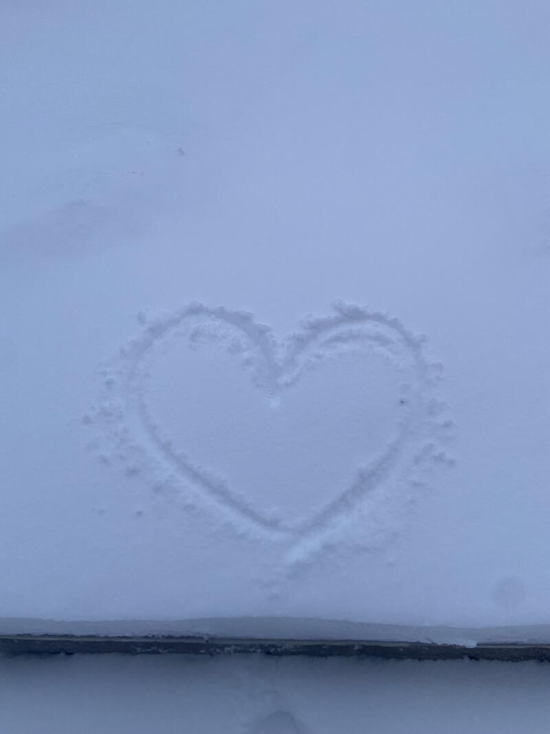 A heart is drawn in the snow.