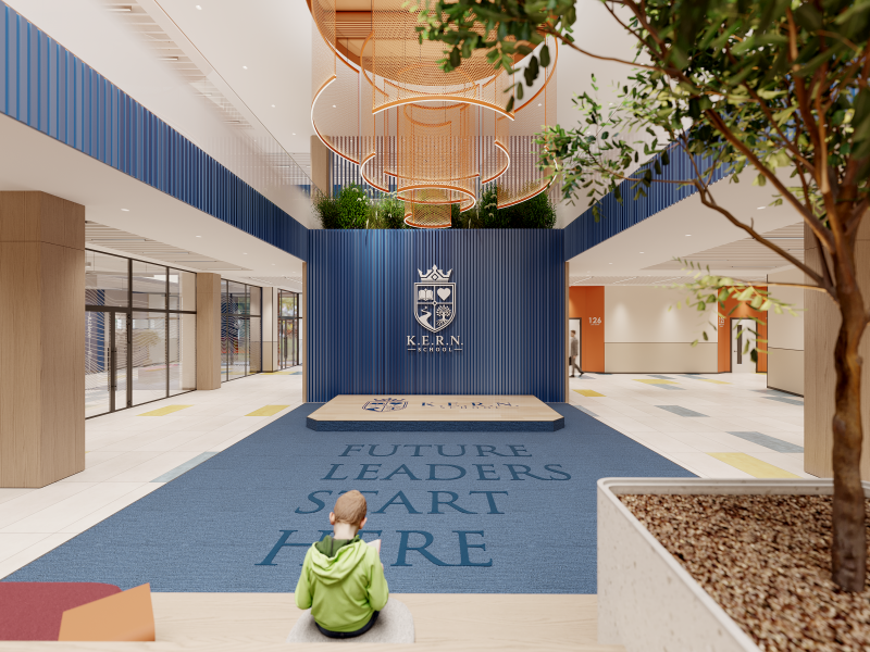 The image shows the interior of K.E.R.N. School with a child sitting on the floor and the words "FUTURE LEADERS START HERE" printed on the blue carpet.