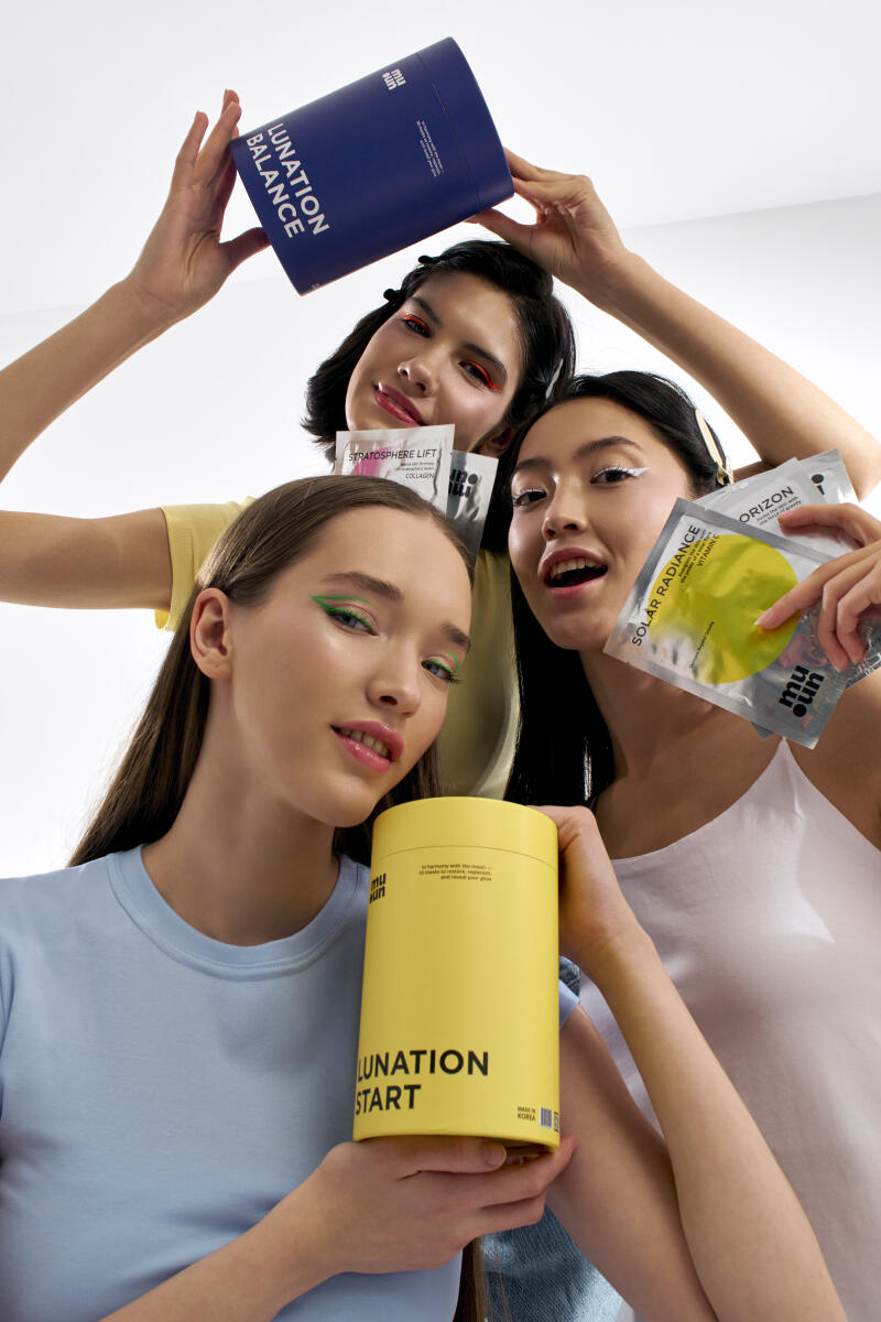 Three women pose with Muun products, including "Lunation Balance", "Stratosphere Lift", "Solar Radiance", and "Lunation Start", while wearing colorful eyeliner.