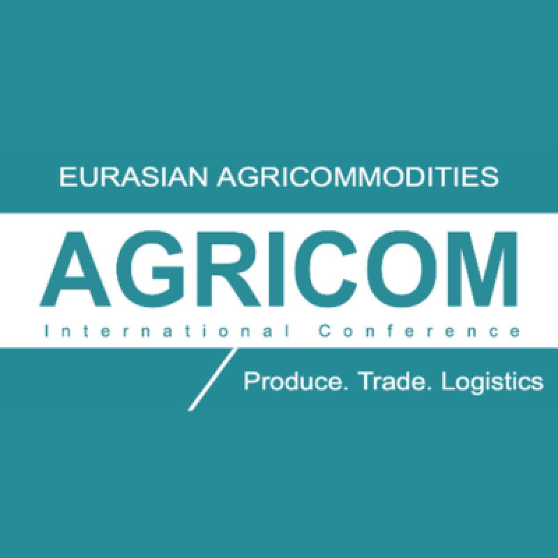 A logo on a teal background with a white horizontal bar, featuring the text "EURASIAN AGRICOMMODITIES" and "AGRICOM International Conference", with the tagline "Produce. Trade. Logistics".