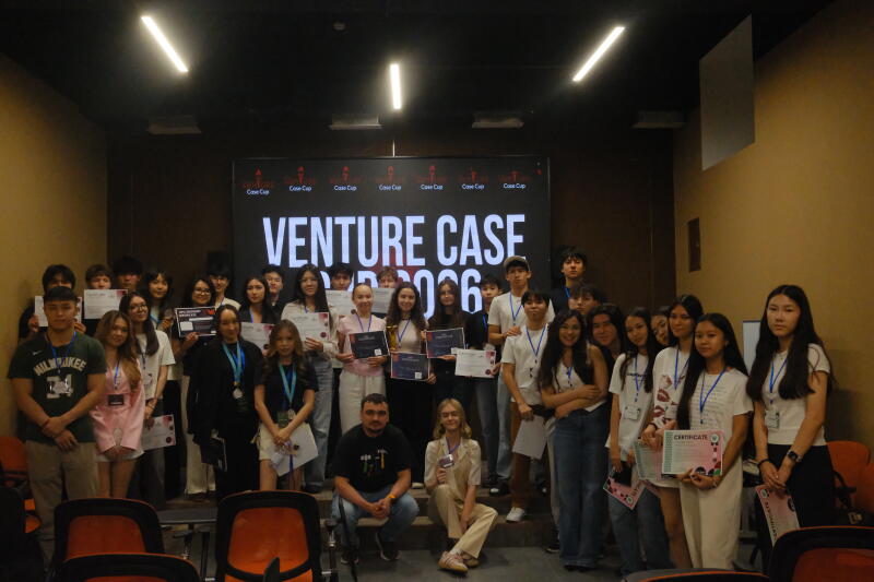 A large group of young people, many holding certificates and some with medals or a trophy, pose for a photo in front of a screen displaying 'VENTURE CASE' and 'Case Cup' logos.