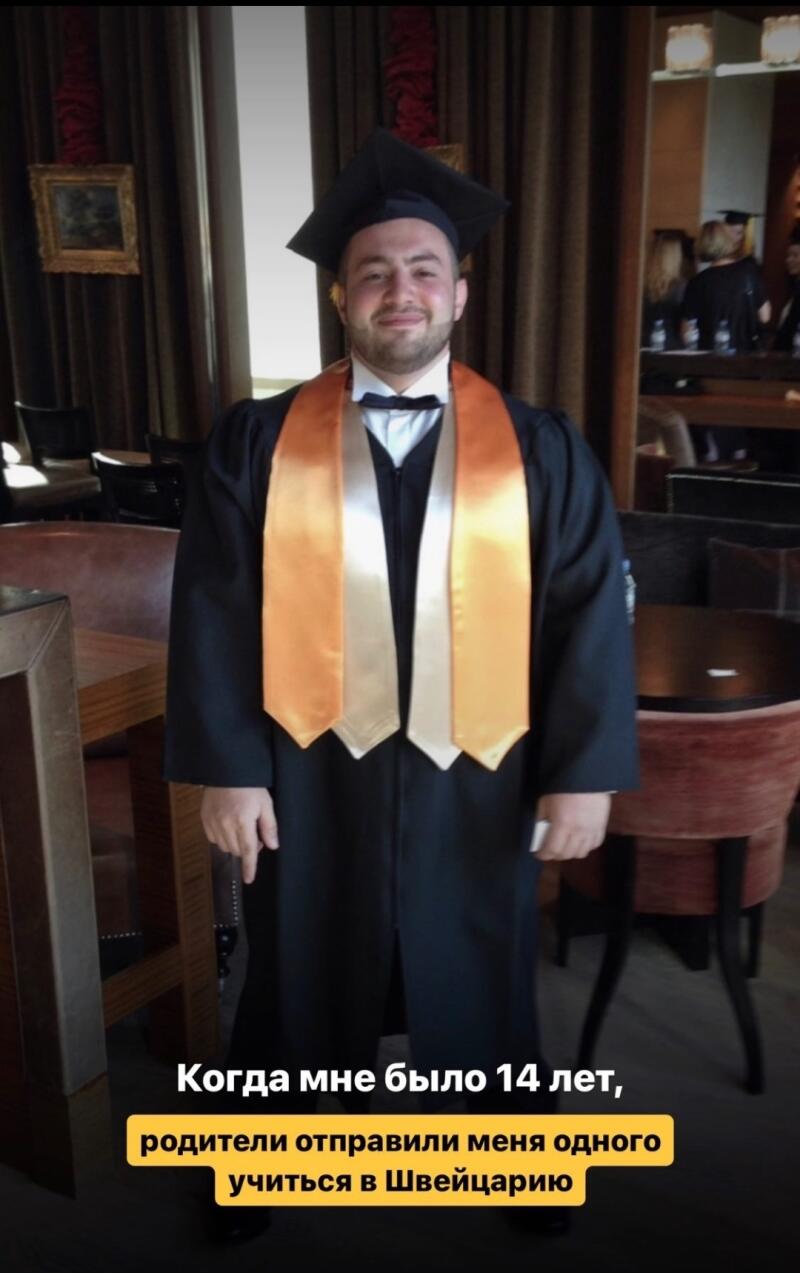 A smiling man in a black graduation gown, mortarboard, and an orange and white academic stole stands indoors, with the text "When I was 14 years old, my parents sent me alone to study in Switzerland" at the bottom.