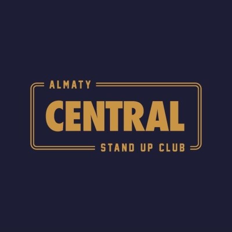 The image displays a logo with the words "ALMATY CENTRAL STAND UP CLUB." The text is in gold letters against a navy-blue background, with a gold rectangular border around the word "CENTRAL."