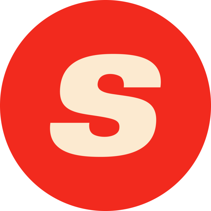 На изображении бежевая буква «S» на красном круге.