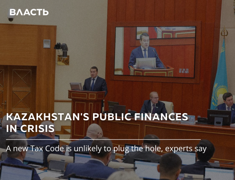 The image shows a meeting or conference setting with officials, a speaker at a podium, and a screen displaying a broadcast of the speaker. The text reads 'KAZAKHSTAN'S PUBLIC FINANCES IN CRISIS' and 'A new Tax Code is unlikely to plug the hole, experts say'.