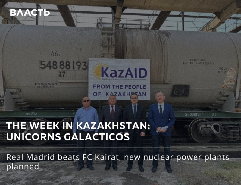 Four men in suits stand in front of a train car with a "KazAID" sign, and text reads "THE WEEK IN KAZAKHSTAN: UNICORNS GALACTICOS" and "Real Madrid beats FC Kairat, new nuclear power plants planned."