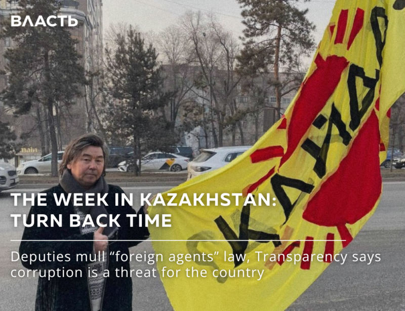 A man stands in front of a street holding a yellow flag with red lettering that reads "Qazaqstan," under the title "The Week in Kazakhstan: Turn Back Time," and a caption about deputies mulling a "foreign agents" law.