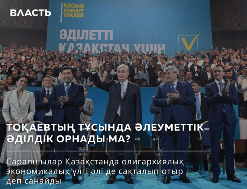 A crowd of people stands in front of a blue banner that reads "Kacbm Jomapt Tokaev Әділетті Қазақстан үшін" with a yellow checkmark. The text on the image says: "ТОҚАЕВТЫҢ ТҰСЫНДА ӘЛЕУМЕТТІК ӘДІЛДІК ОРНАДЫ МА? Сарапшылар Қазақстанда олигархиялық экономикалық үлгі әлі де сақталып отыр деп санайды."