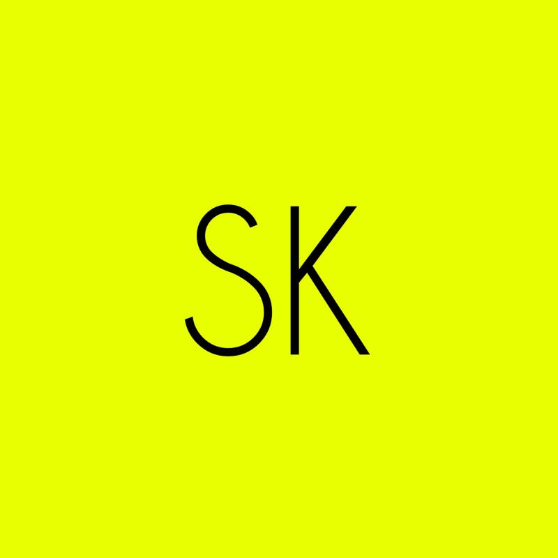The image features the letters 'SK' in black against a bright yellow background.